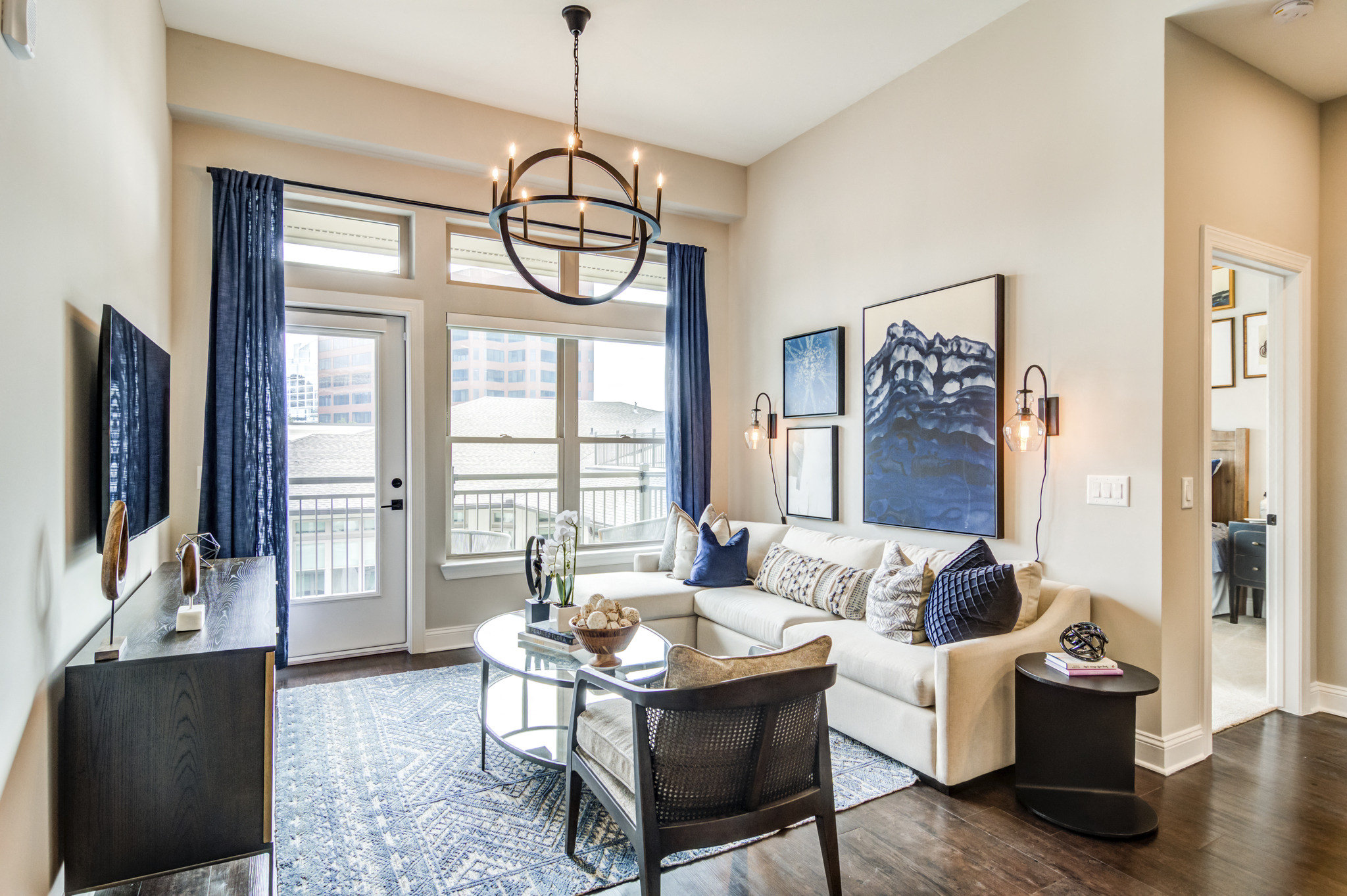 a living room with a white couch and a glass coffee table